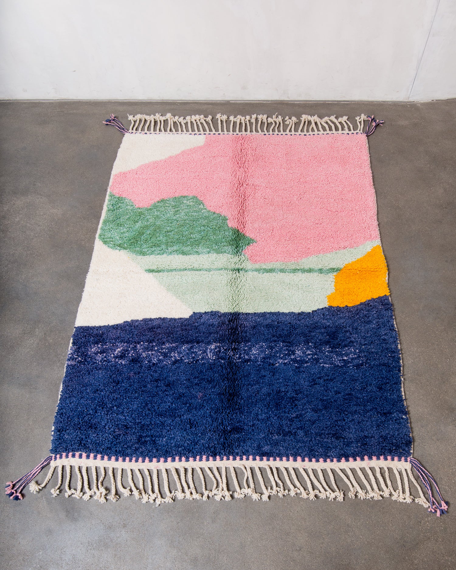 Berberlin Beniourain rug in fluffy wool, laying flat on concrete studio floor.